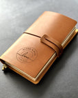 Handmade refillable leather wedding journal with engraved love circle design