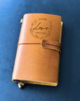 Open page of leather diary showing personalised message