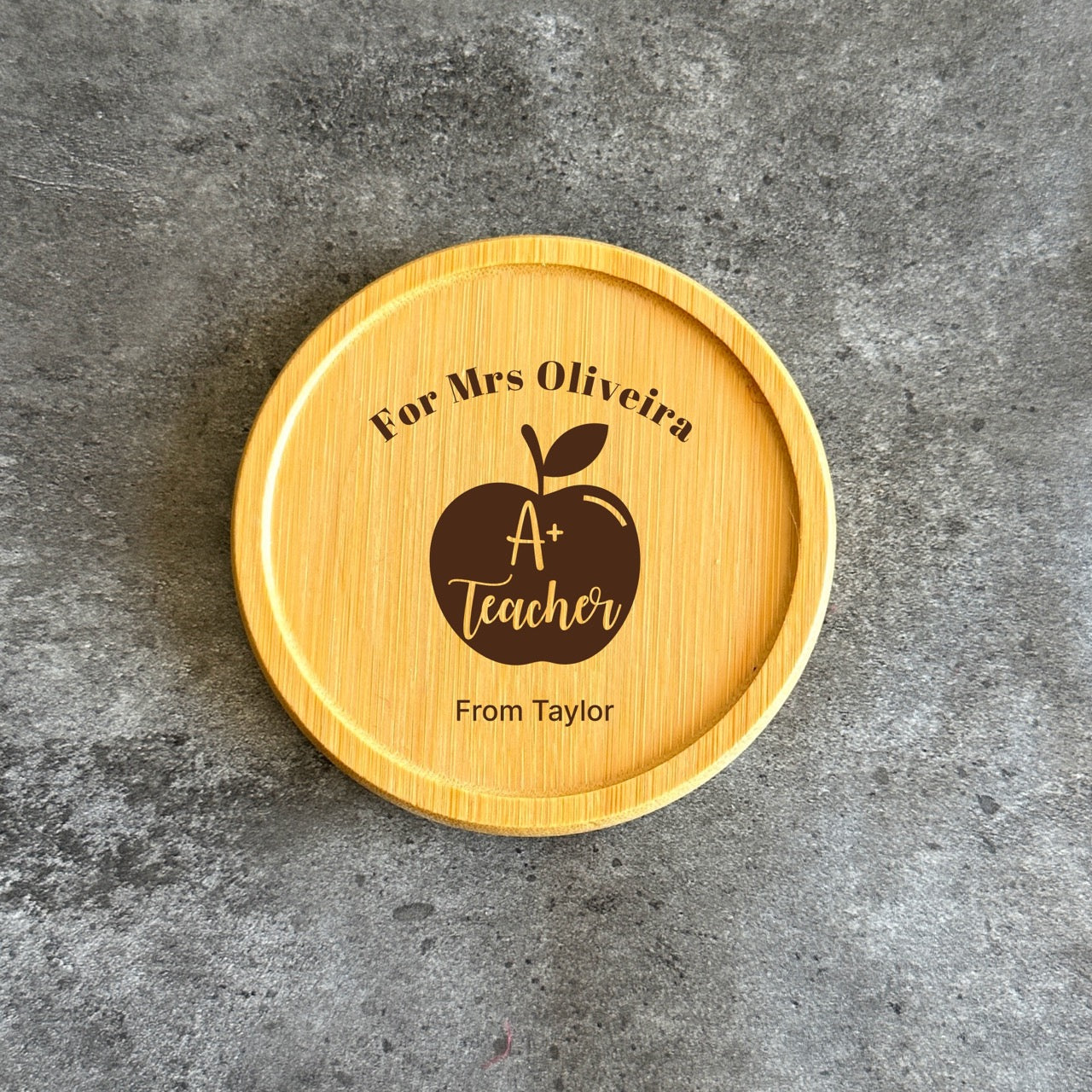 A wooden coaster with a personalized message engraved on it.