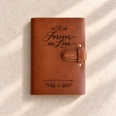 Personalised thick leather anniversary journal engraved with Forever in Love lettering, intertwined hearts and leafy branches.