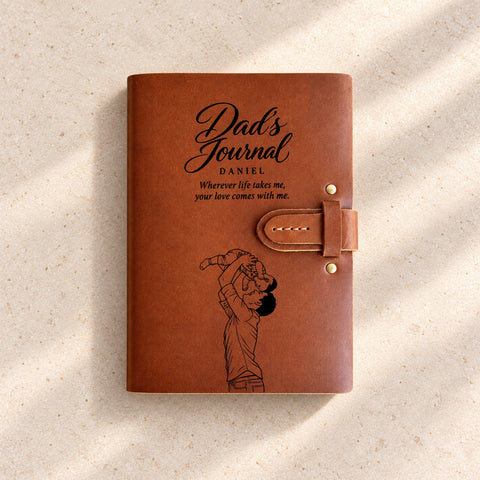 Thick leather journal with a strap closure, Daniel’s name, Dad’s Journal wording and a portrait of a father lifting his child.