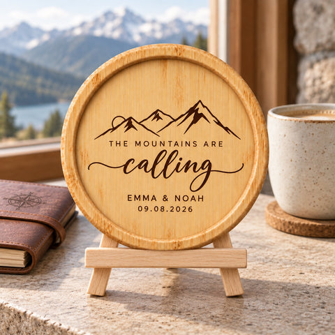 Wooden coaster engraved with the The Mountains Are Calling mountain design
