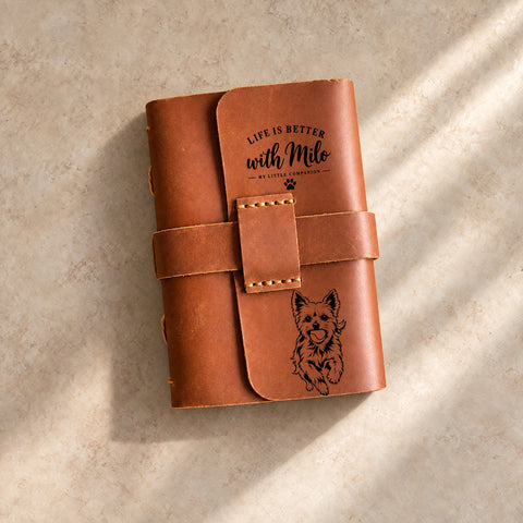 Leather strap closure journal engraved with one dog’s portrait and name.