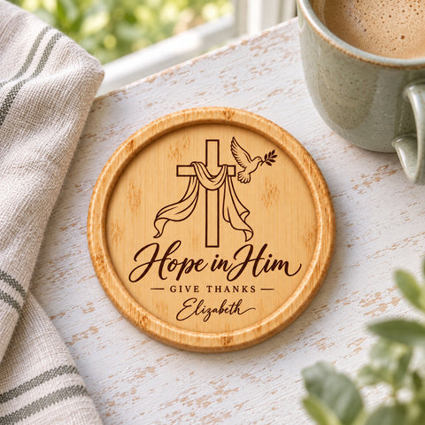 Wooden faith coaster with a draped cross, dove and Hope in Him engraving.