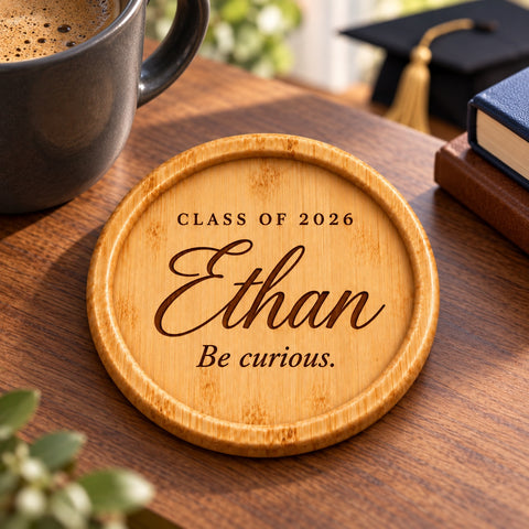 Close-up of a personalised name and graduation year engraved on a wooden coaster.