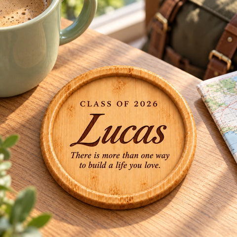 Personalised graduation coaster with a mug on a desk.