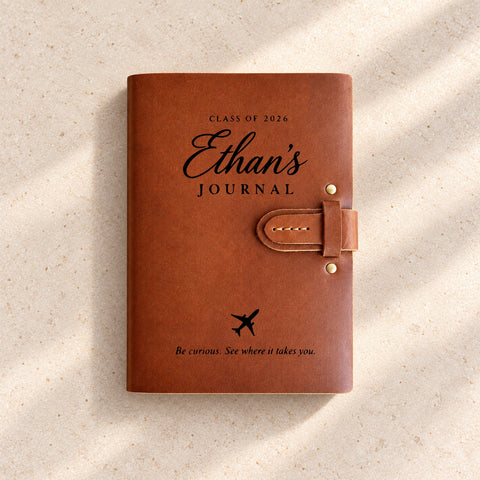Thick leather notebook with a name and personal quote engraved on the cover.