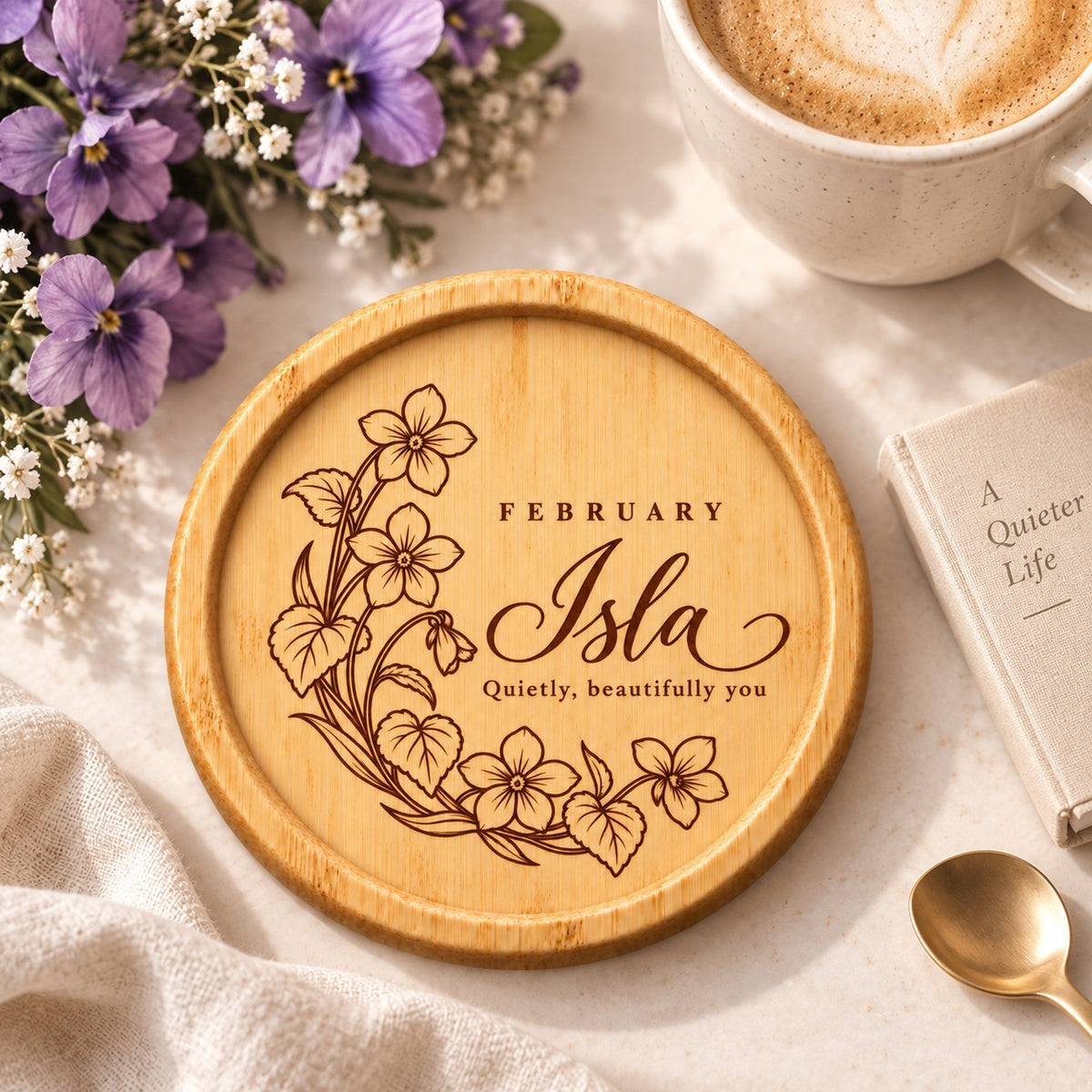 February birth flower bamboo coaster engraved with Isla and the message Quietly, beautifully you