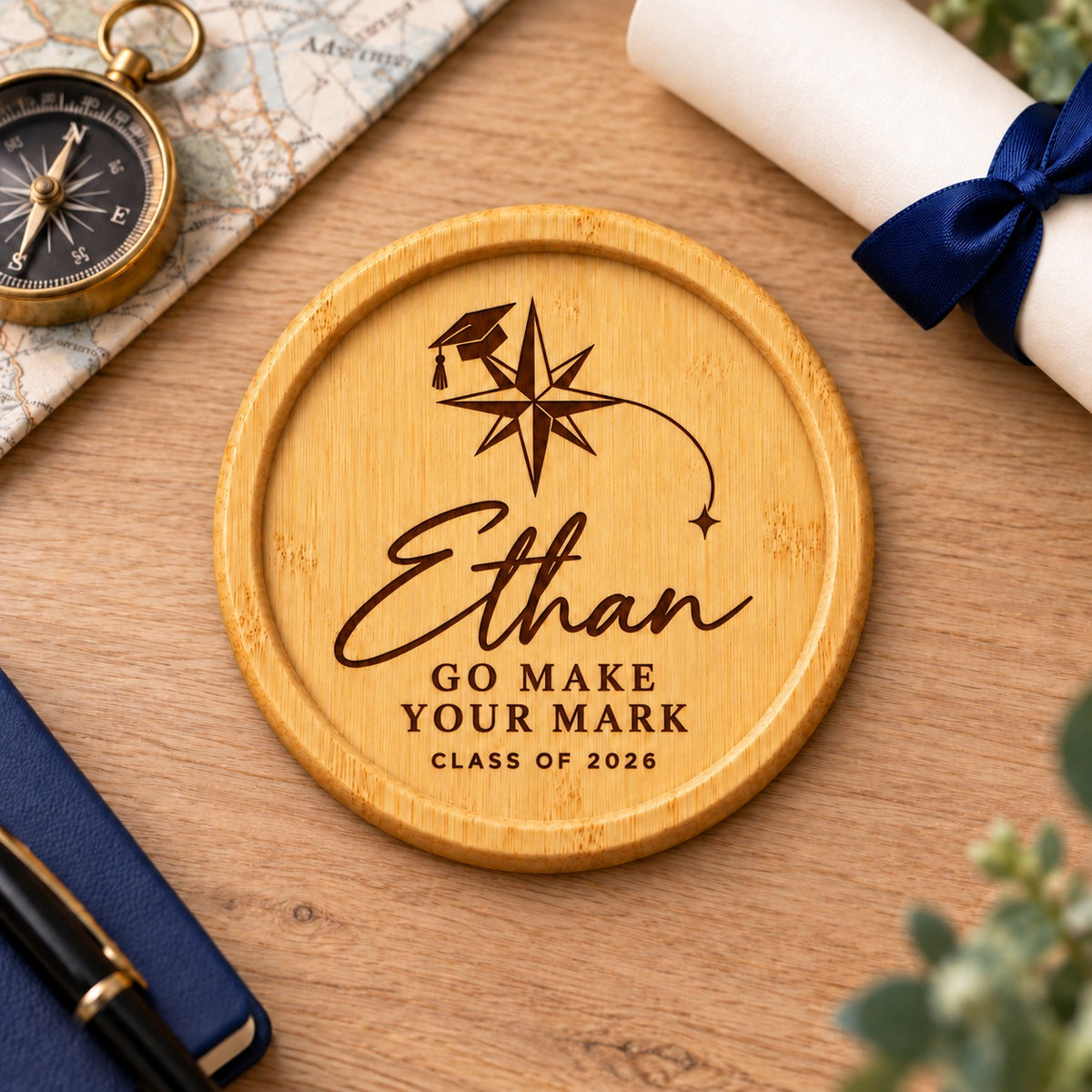 Bamboo graduation coaster engraved with a personalised name, compass artwork and Go Make Your Mark message