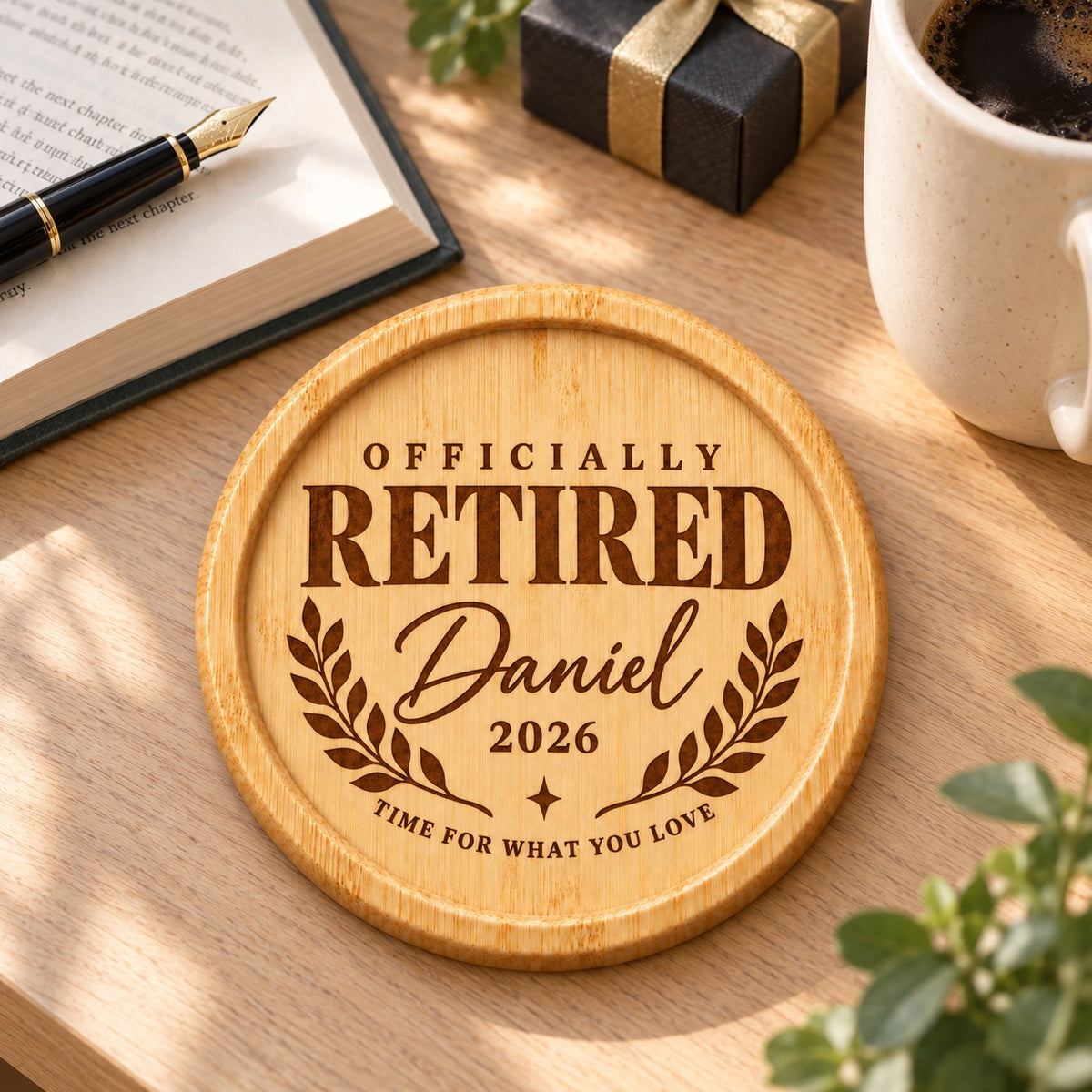 Bamboo retirement coaster engraved with Officially Retired, Daniel, 2026 and a laurel design