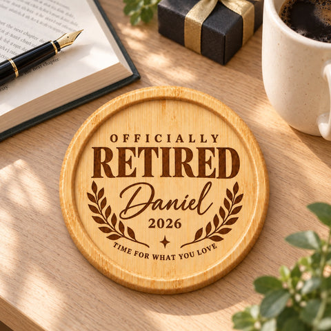 Bamboo retirement coaster engraved with Officially Retired, Daniel, 2026 and a laurel design