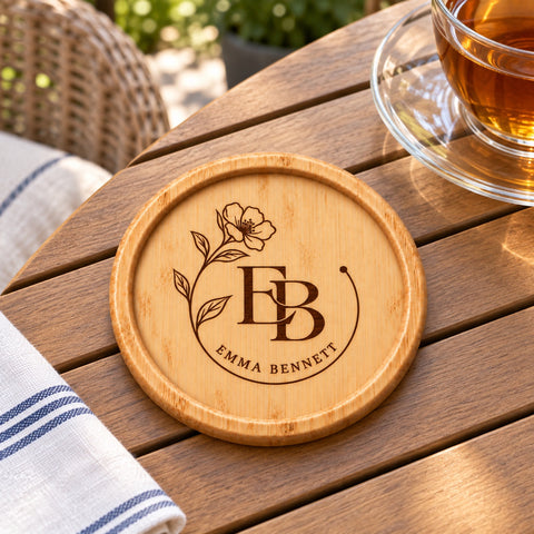 Round wooden coaster engraved with a botanical monogram and personalised name