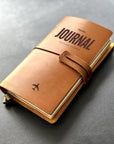 Handmade refillable leather travel journal with engraved airplane icon