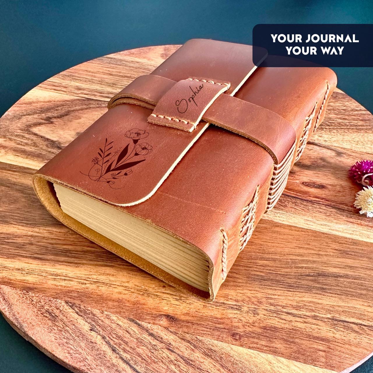Brown refillable leather notebook with strap and floral art