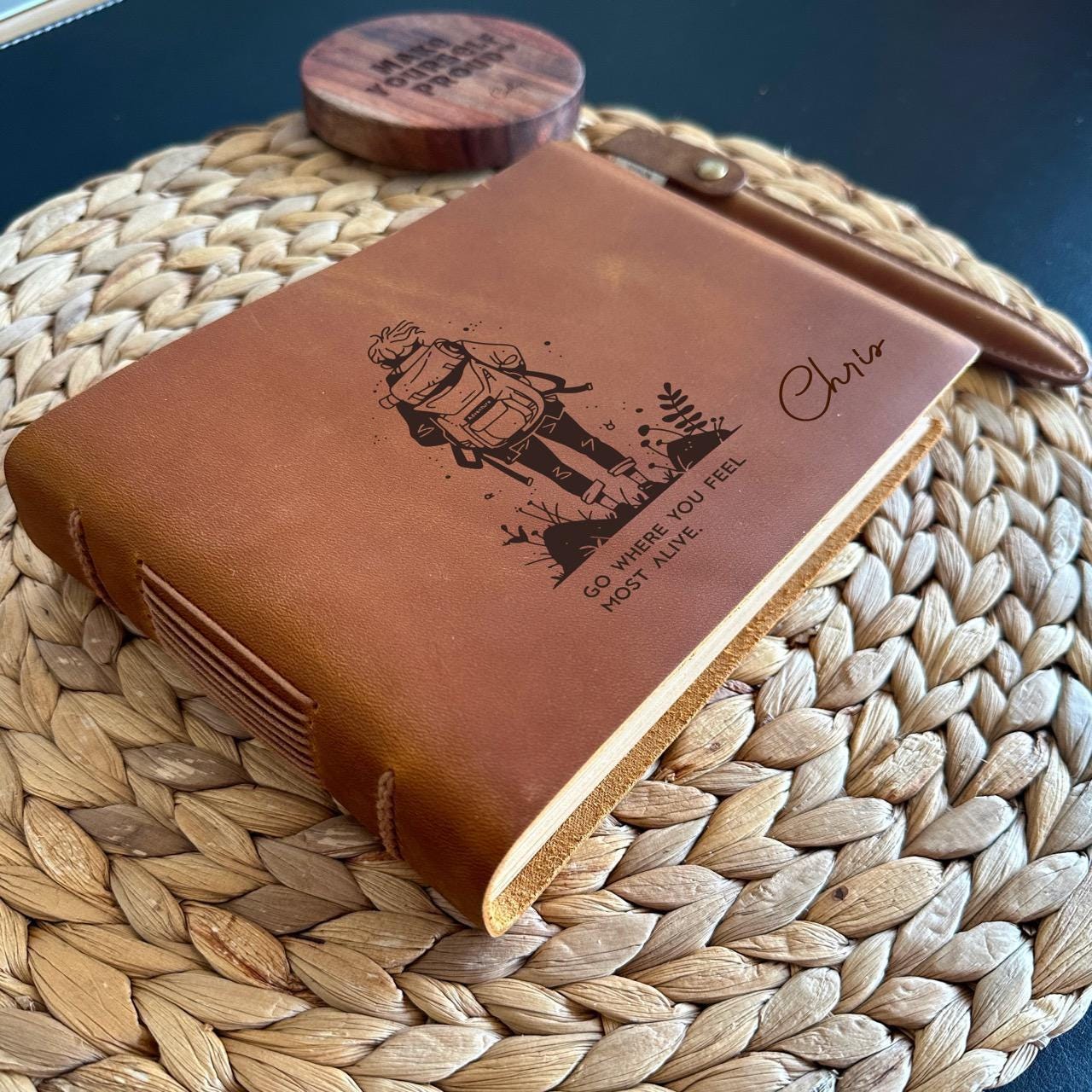 Handmade leather adventure journal with engraved hiking traveller design