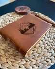Handmade leather journal with engraved mountain and forest crest design
