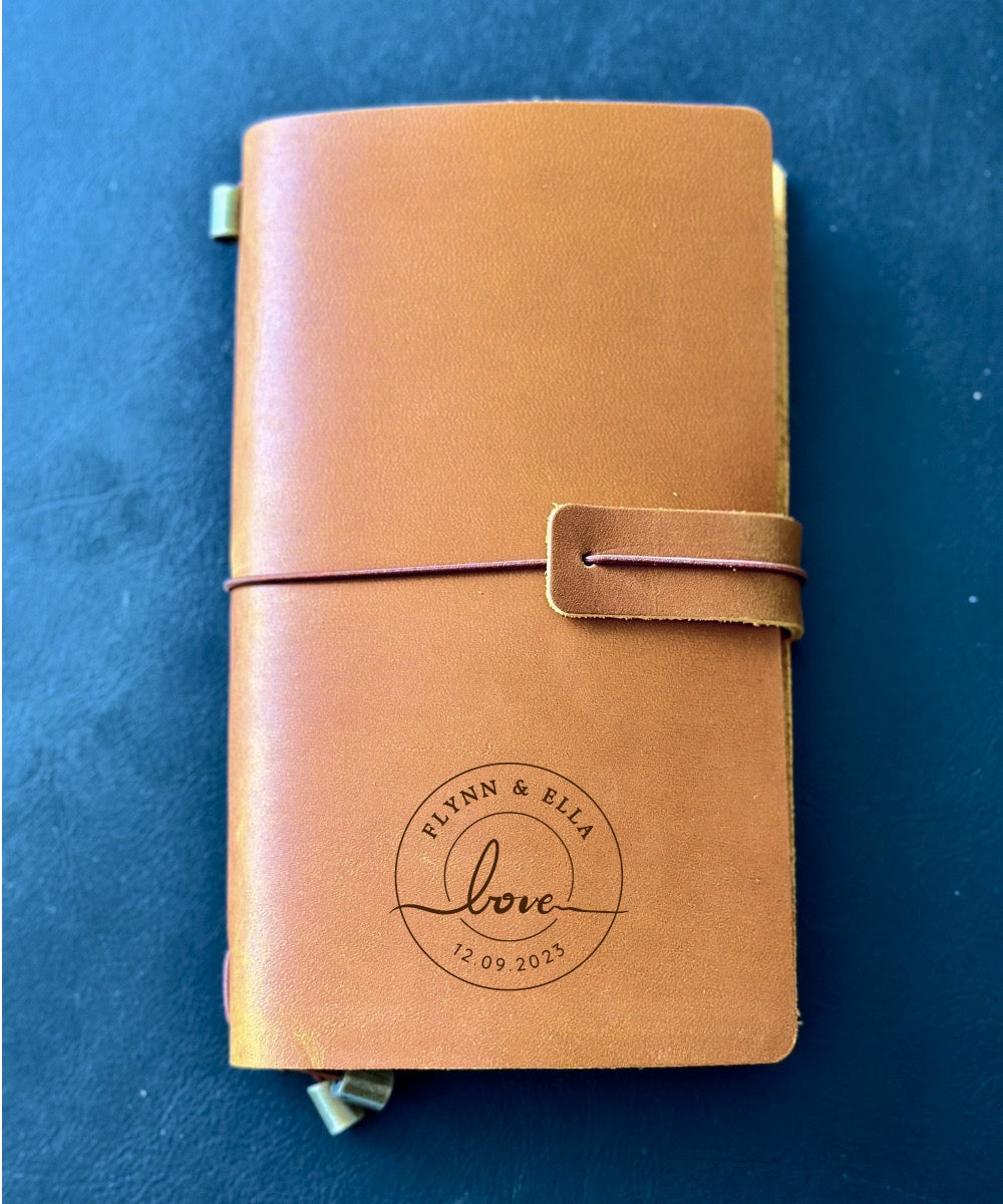 Leather journal engraved with names, a memorable wedding keepsake.