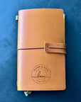 Leather journal engraved with names, a memorable wedding keepsake.