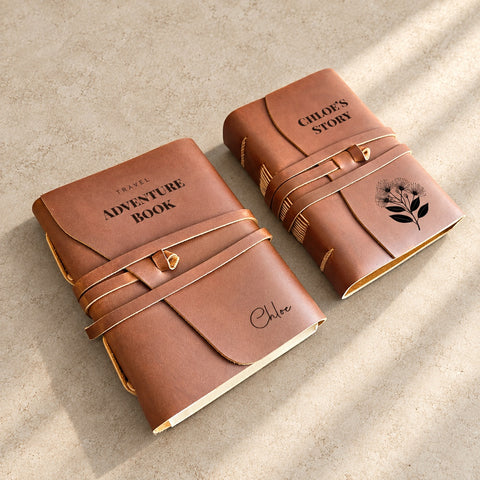 Two brown leather wrap journals with Adventure Book and floral Story Journal cover designs